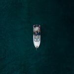 a small boat floating on top of a large body of water