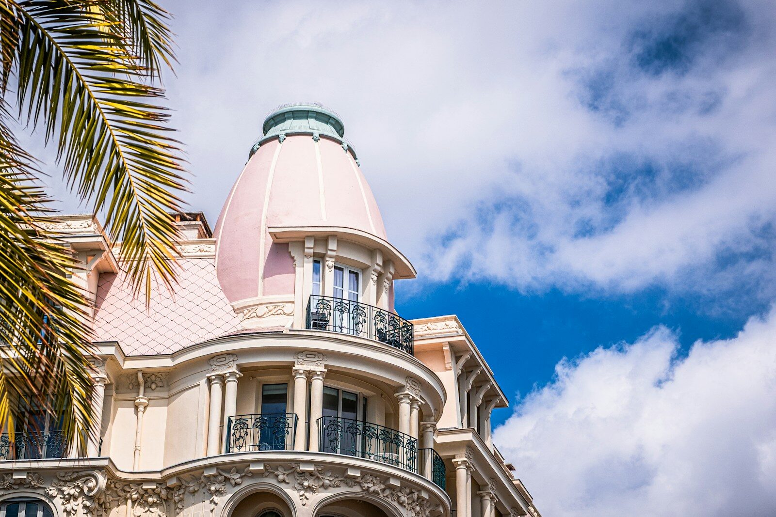 Ornate building with pink dome against blue sky