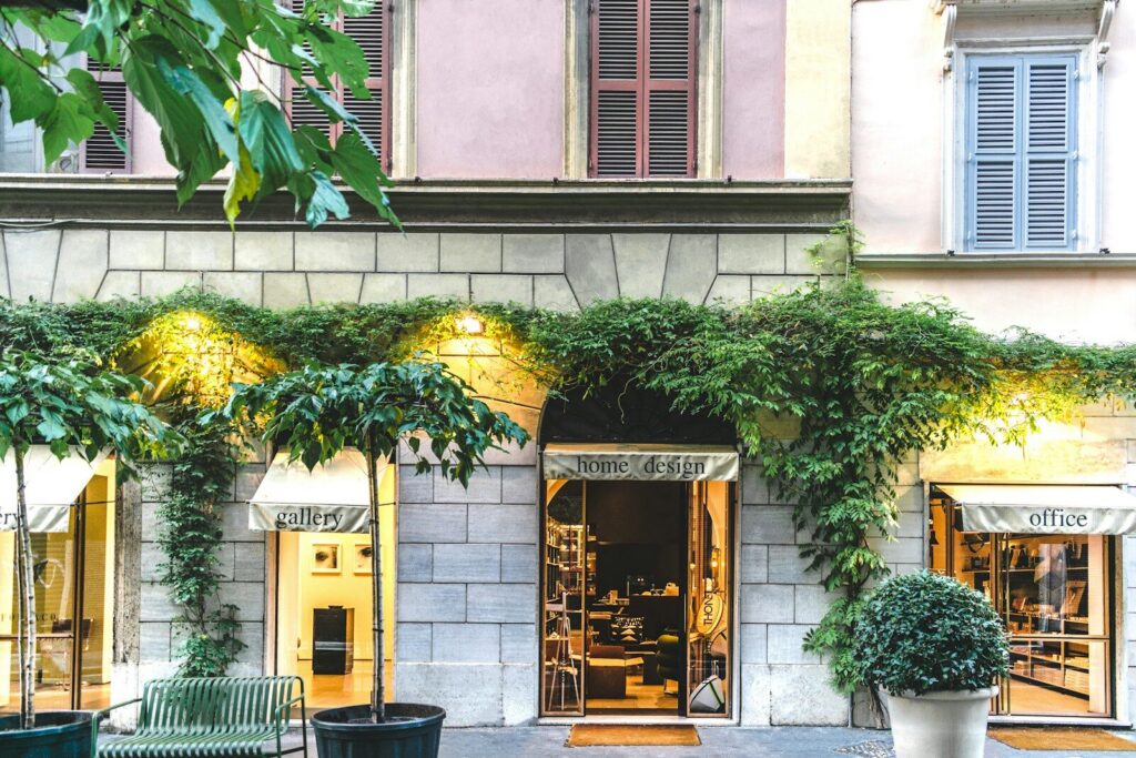 A traveller checking a phone outside a boutique hotel, representing the shift to AI-driven hotel discovery and booking