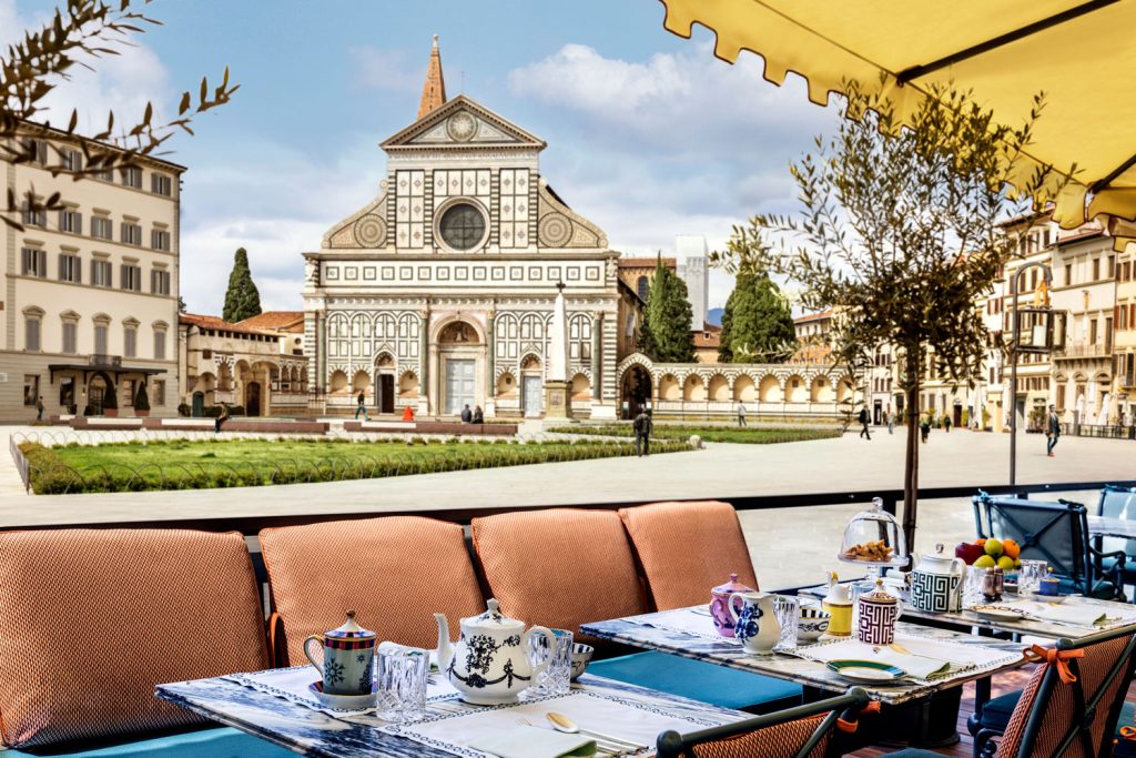 Tables on The Place Firenze’s terrace overlooking the Basilica of Santa Maria Novella in Florence.